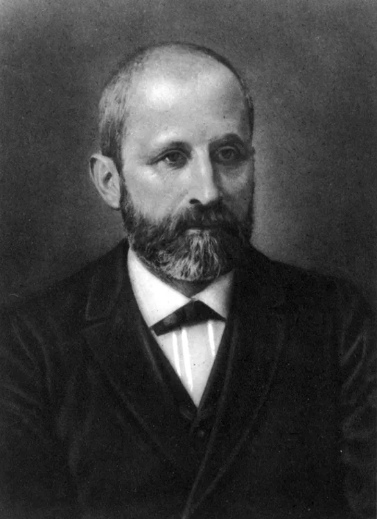 A black-and-white archival portrait photograph of Friedrich Miescher: a balding man with a full beard and mustache, wearing a dark suit, white collar, and dark necktie, gazing slightly to the side.