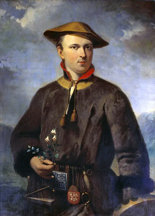 An oil portrait of a young man in fur-trimmed brown clothing and a wide-brimmed hat, holding a small flowering plant in one hand, with a patterned case and a round red seal or pouch resting near his other hand.